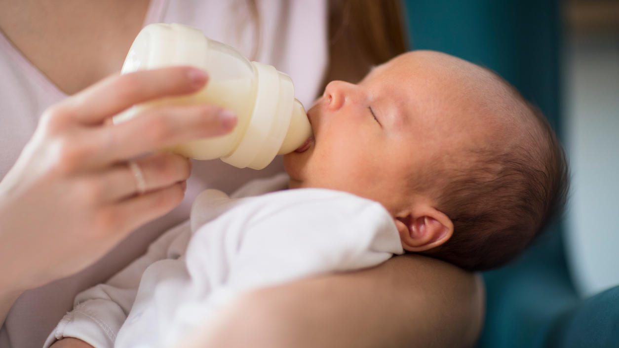 Il bambino viene nutrito dal biberon con latte artificiale